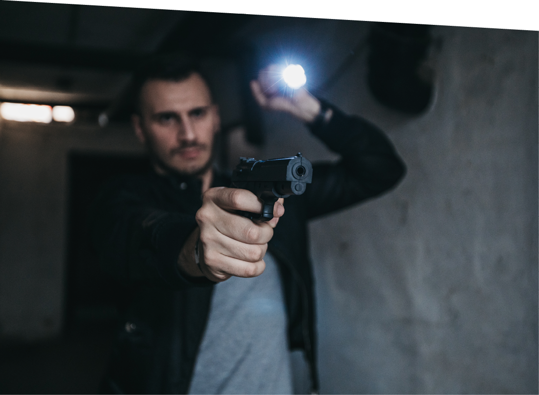 Young Caucasian male FBI agent with a gun and flashlight on a mission.